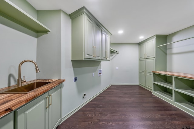 laundry area with cabinet space, dark wood-type flooring, electric dryer hookup, washer hookup, and a sink