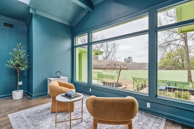 sitting room featuring crown molding, visible vents, vaulted ceiling, wood finished floors, and baseboards