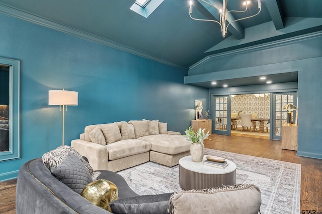 living room featuring lofted ceiling with skylight, crown molding, baseboards, and wood finished floors