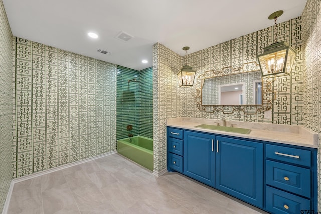 full bath featuring  shower combination, vanity, visible vents, and tile walls