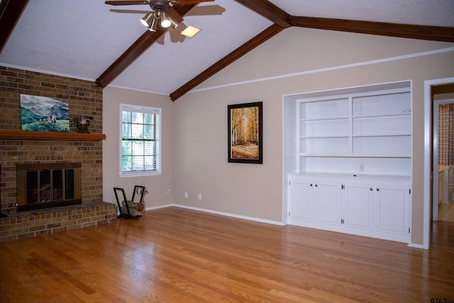 3505 Cloverdale Dr, Tyler, TX 75701 - unfurnished living room with ceiling fan, wood finished floors, a fireplace, and built in features