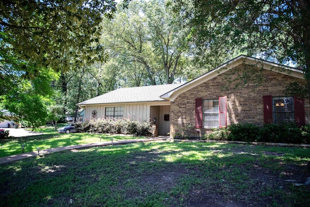 3505 Cloverdale Dr, Tyler, TX 75701 - single story home with board and batten siding, a front yard, and brick siding