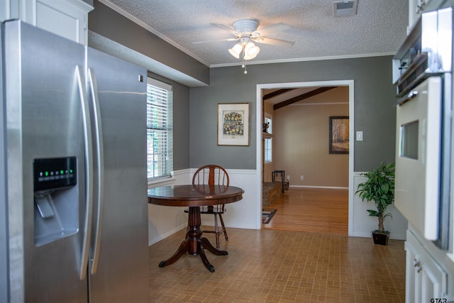 3505 Cloverdale Dr, Tyler, TX 75701 - dining area with crown molding, ceiling fan, and a textured ceiling