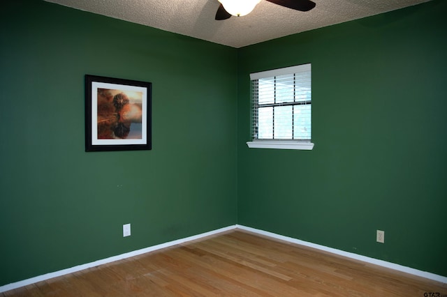 3505 Cloverdale Dr, Tyler, TX 75701 - spare room featuring a textured ceiling, baseboards, wood finished floors, and ceiling fan