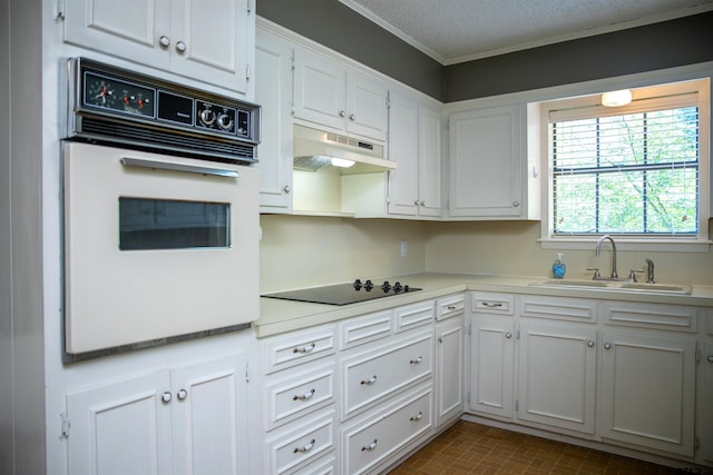 3505 Cloverdale Dr, Tyler, TX 75701 - kitchen featuring a sink, white oven, black electric stovetop, under cabinet range hood, and light countertops