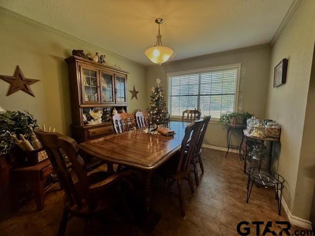 dining room with dark hardwood / wood-style floors and ornamental molding