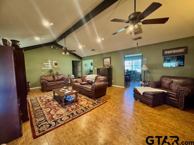 living room featuring hardwood / wood-style flooring and lofted ceiling with beams