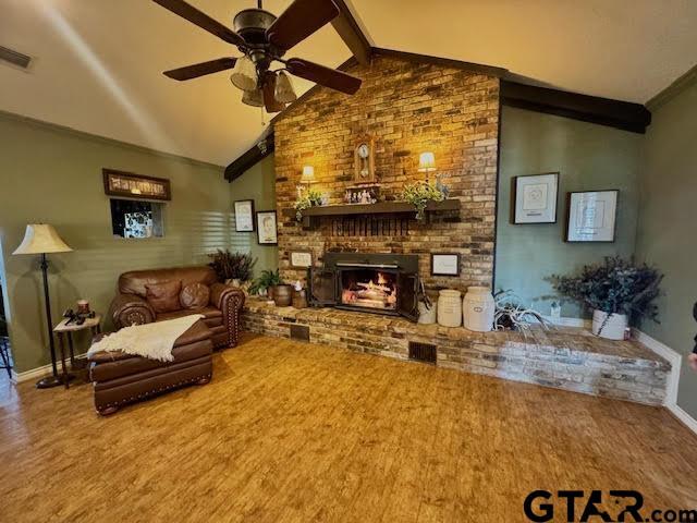 12239 Lovers Ln, Larue, TX 75770 - living area with ceiling fan, wood finished floors, and a fireplace