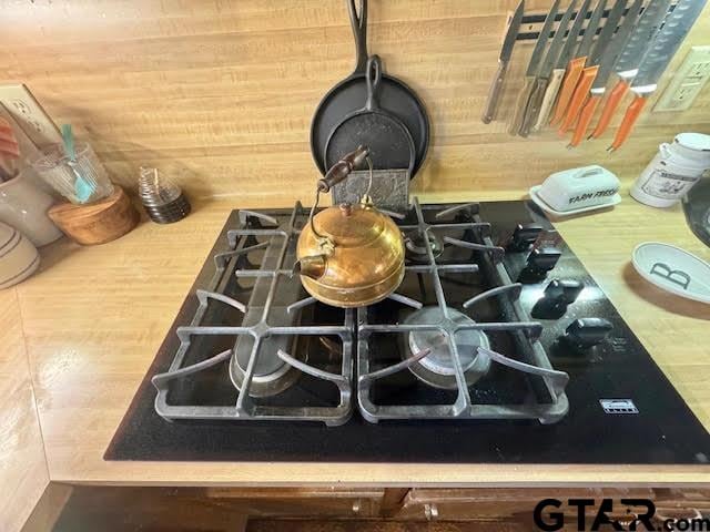 room details featuring light countertops and black gas cooktop