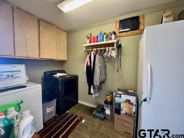 washroom with cabinets and washing machine and dryer