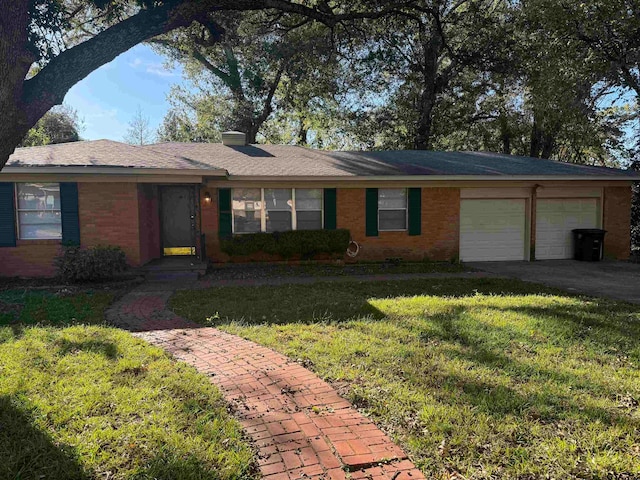 single story home featuring a garage and a front lawn