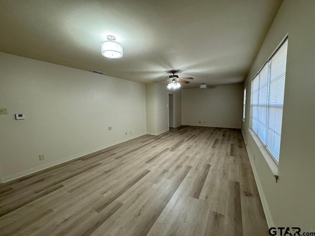 unfurnished room with ceiling fan and light hardwood / wood-style flooring