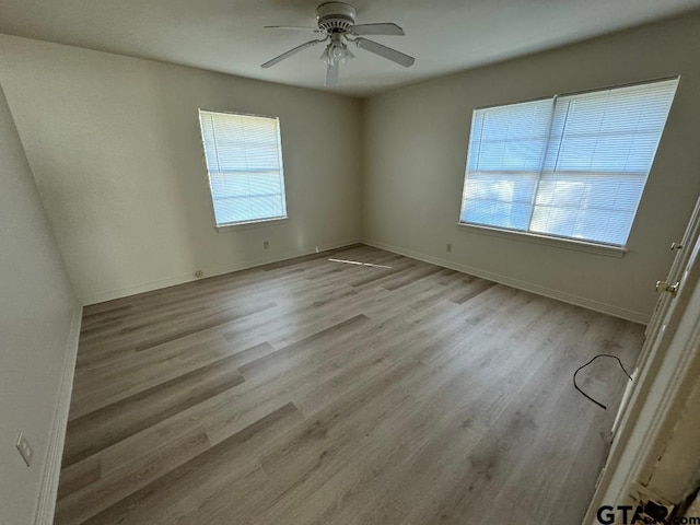 empty room featuring ceiling fan and light hardwood / wood-style floors