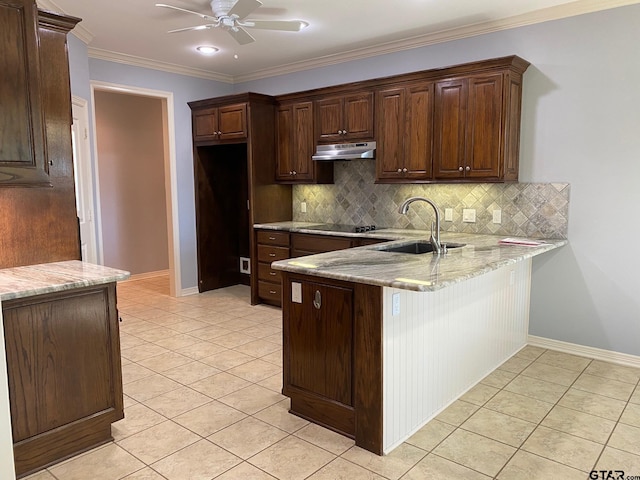 kitchen featuring light stone countertops, decorative backsplash, light tile patterned floors, and sink