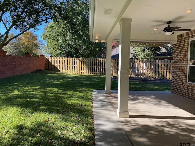 view of yard featuring ceiling fan and a patio area