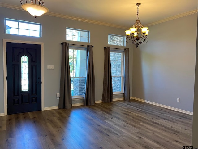 entrance foyer with a wealth of natural light, dark wood-type flooring, and ornamental molding