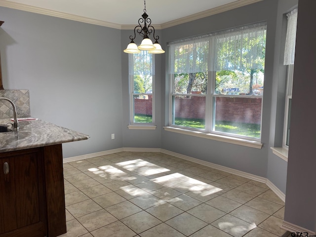 unfurnished dining area featuring a notable chandelier, sink, light tile patterned floors, and crown molding