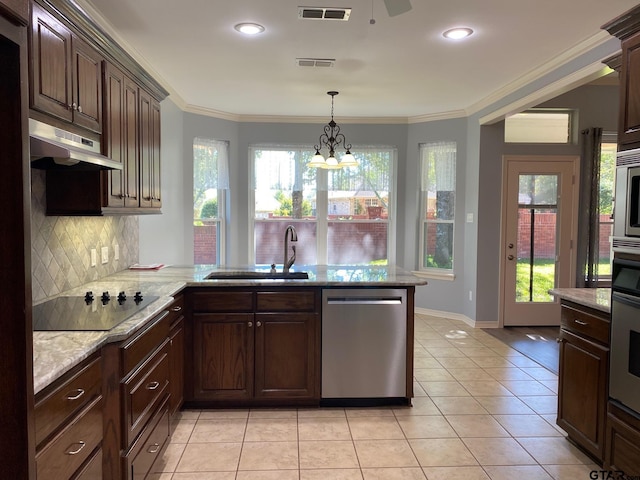 kitchen with kitchen peninsula, stainless steel appliances, crown molding, sink, and a chandelier