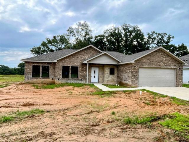 225 S Quille Ave, Mount Pleasant, TX 75455 - ranch-style house featuring an attached garage, brick siding, driveway, and roof with shingles