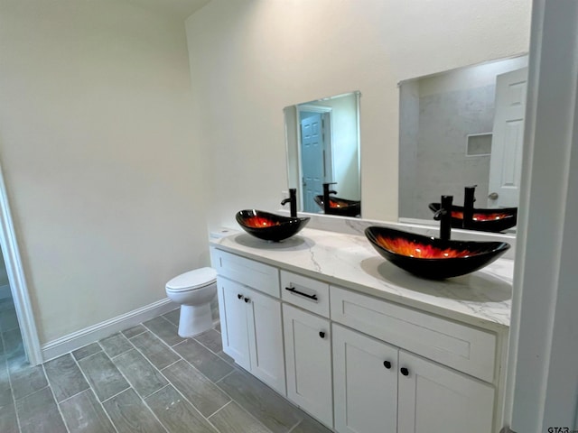 225 S Quille Ave, Mount Pleasant, TX 75455 - bathroom featuring double vanity and toilet