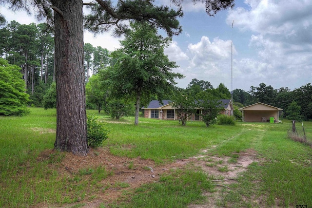 19870 Fm 1253, Lindale, TX 75771 - view of green lawn with a carport and driveway