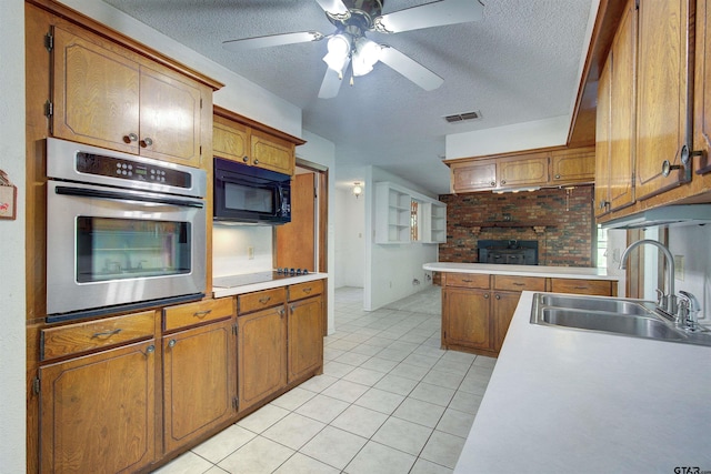 19870 Fm 1253, Lindale, TX 75771 - kitchen with black appliances, light tile patterned floors, brown cabinets, light countertops, and a textured ceiling