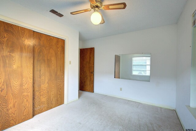 19870 Fm 1253, Lindale, TX 75771 - unfurnished bedroom with carpet floors, a ceiling fan, a closet, and a textured ceiling