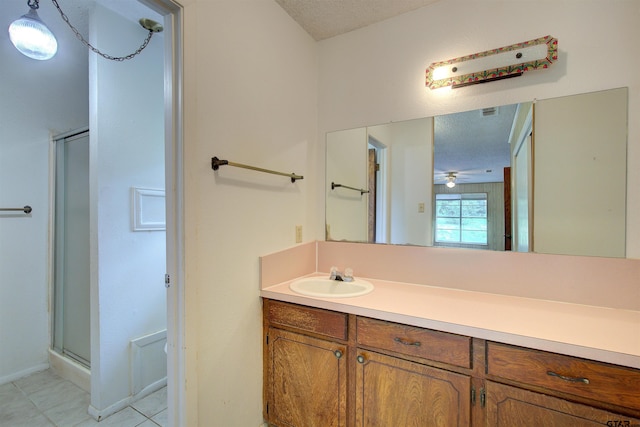 19870 Fm 1253, Lindale, TX 75771 - full bath with vanity, a stall shower, tile patterned floors, and a textured ceiling