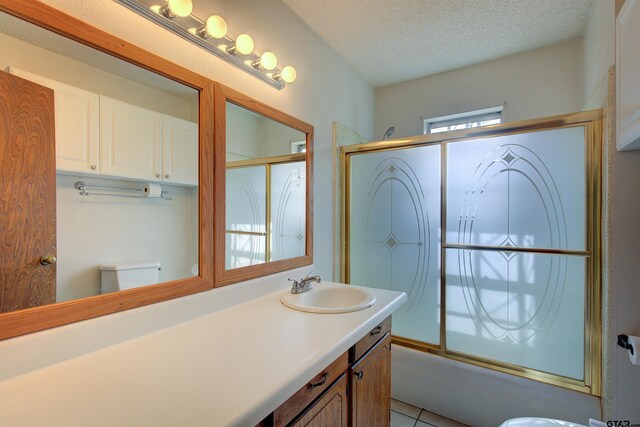 19870 Fm 1253, Lindale, TX 75771 - full bathroom with shower / bath combination with glass door, vanity, a textured ceiling, and tile patterned flooring