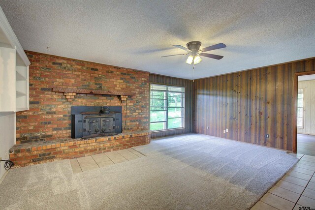 19870 Fm 1253, Lindale, TX 75771 - unfurnished living room with ceiling fan, tile patterned floors, wooden walls, and a textured ceiling
