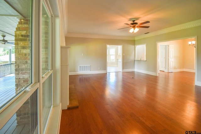 spare room with hardwood / wood-style flooring, ceiling fan, and crown molding