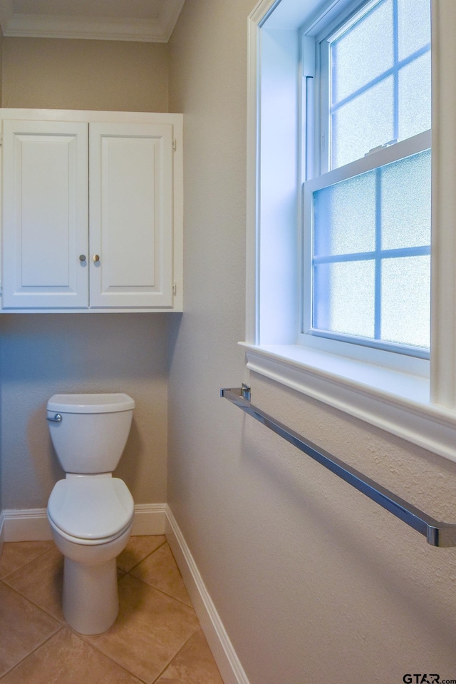 bathroom with toilet, tile patterned floors, and crown molding