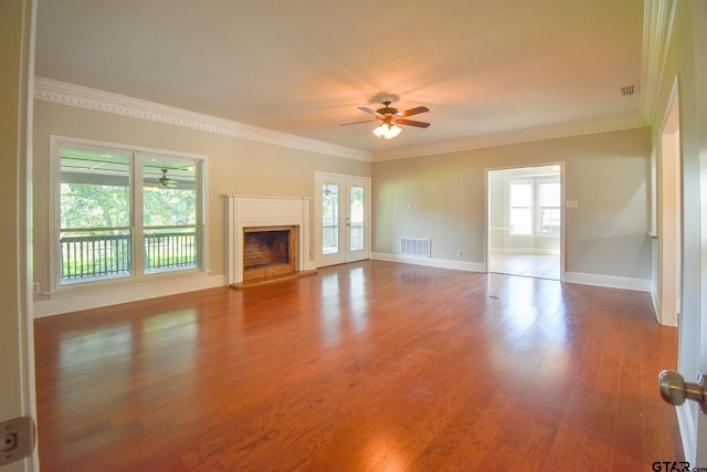 unfurnished living room featuring hardwood / wood-style flooring, ceiling fan, and a healthy amount of sunlight