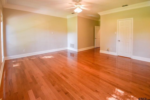 empty room featuring ceiling fan, hardwood / wood-style floors, and ornamental molding