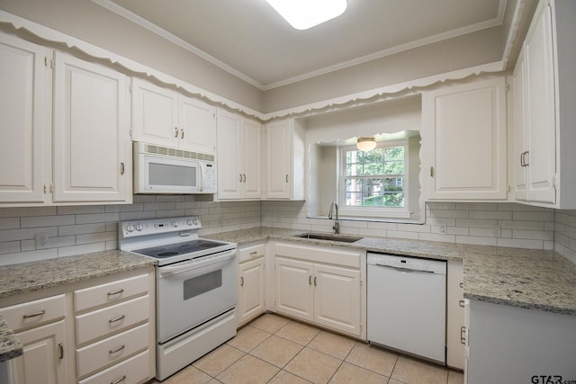 kitchen with white cabinets, sink, light tile patterned floors, ornamental molding, and white appliances