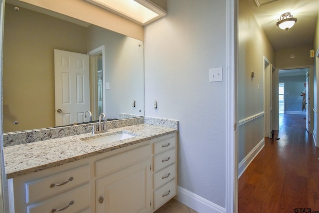 bathroom featuring vanity and hardwood / wood-style floors