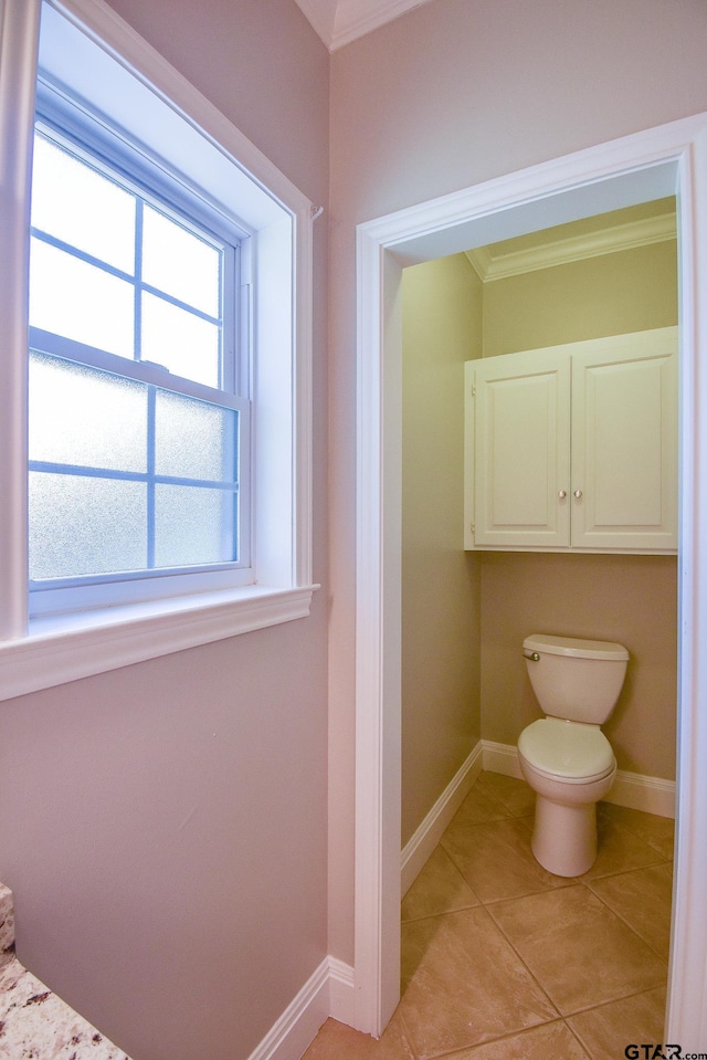 bathroom featuring tile patterned flooring, toilet, and ornamental molding