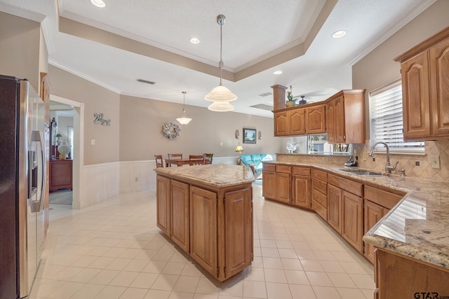 kitchen featuring backsplash, crown molding, sink, light tile patterned floors, and appliances with stainless steel finishes