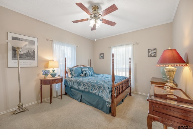 carpeted bedroom featuring ceiling fan, ornamental molding, and multiple windows