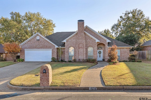 view of front of property with a front yard and a garage