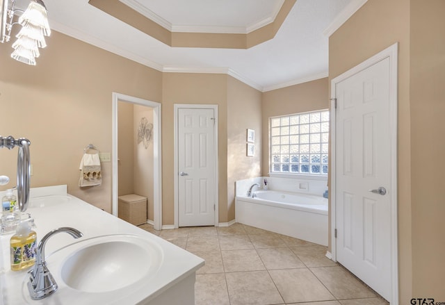 bathroom with vanity, a bathing tub, a raised ceiling, tile patterned flooring, and ornamental molding