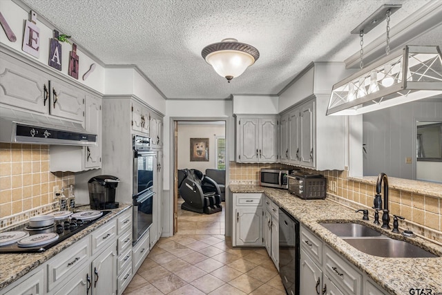 kitchen with crown molding, under cabinet range hood, decorative backsplash, black appliances, and a sink