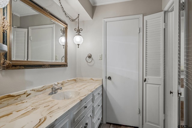 bathroom with ornamental molding and vanity