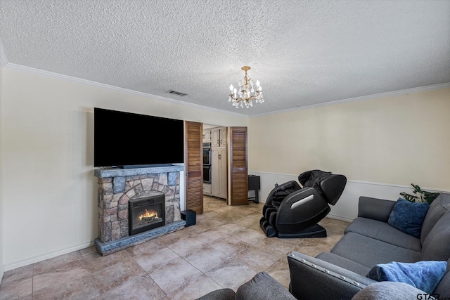 living area featuring visible vents, a notable chandelier, a textured ceiling, a fireplace, and crown molding