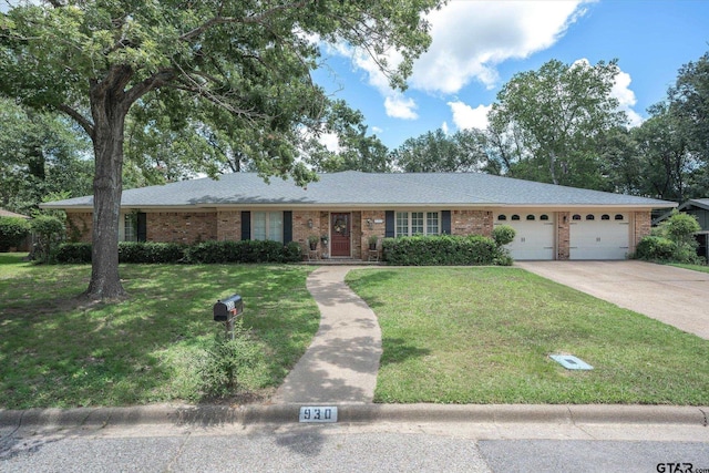 ranch-style house featuring a front lawn, concrete driveway, an attached garage, a shingled roof, and brick siding