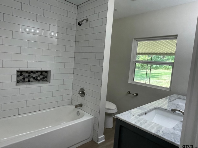 full bathroom with vanity, toilet, and tiled shower / bath