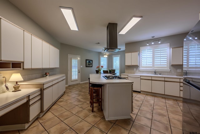 10074 Hillside Ln, Flint, TX 75762 - kitchen with dishwasher, island range hood, light countertops, white cabinetry, and gas cooktop