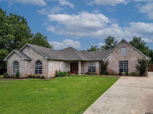 10074 Hillside Ln, Flint, TX 75762 - view of front of house featuring brick siding, a front yard, and roof with shingles