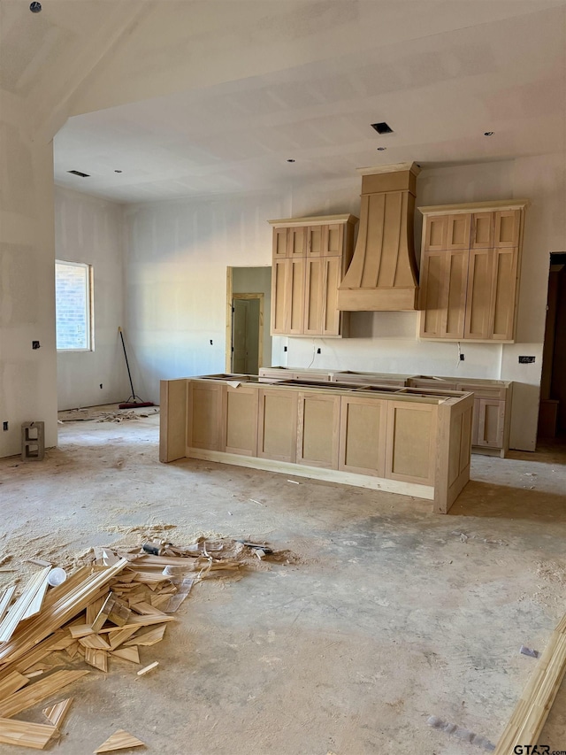 kitchen with custom exhaust hood and light brown cabinets