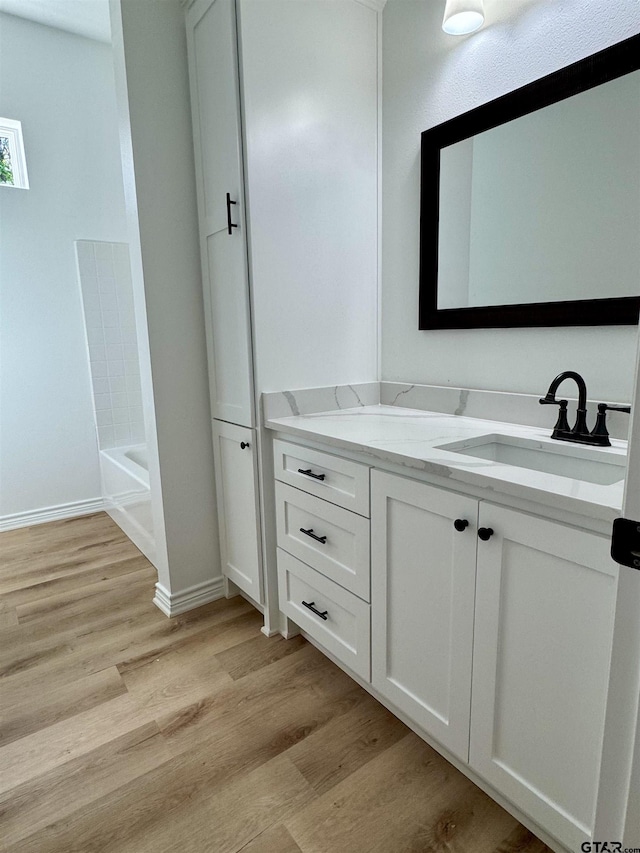 15939 Shepards Gln, Lindale, TX 75771 - full bathroom with wood finished floors, vanity, and a tub to relax in